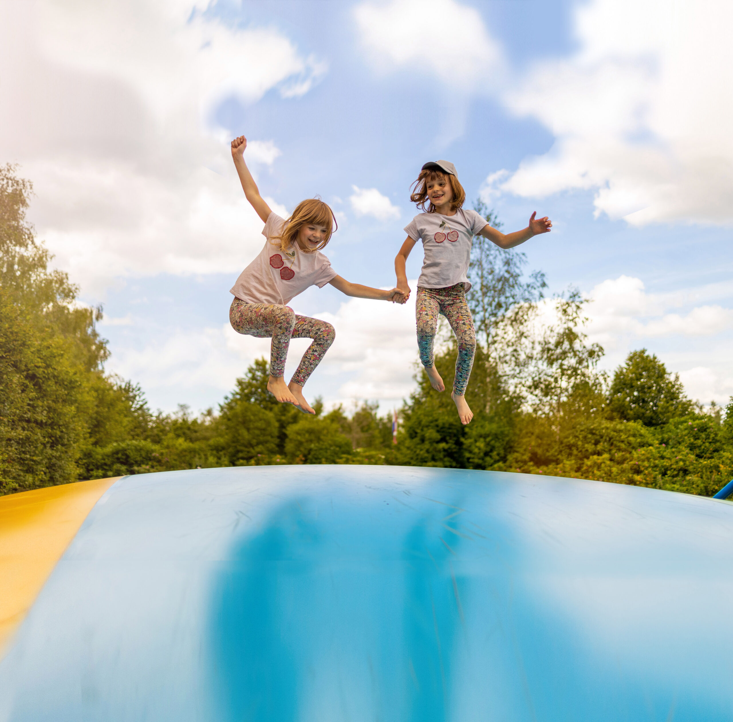 Happy children jumping on inflatable bouncer